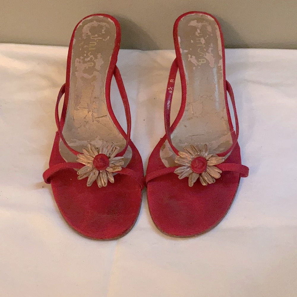 Worn red sandals with kitten heel